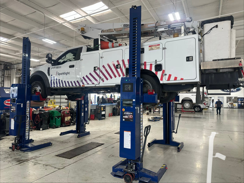 Commercial fleet workshop with vehicle lifts and compressed air systems