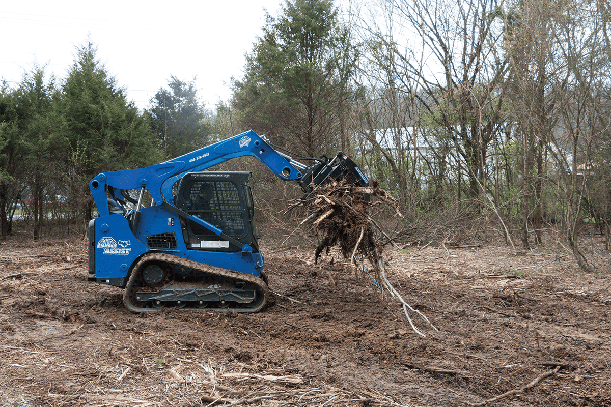 Blue Diamond Heavy Duty Grapple Rake — mounted on a compact track loader handling brush