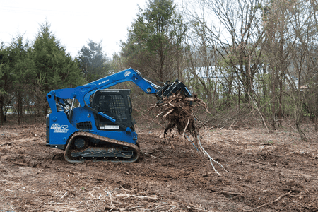 Blue Diamond Heavy Duty Grapple Rake — mounted on a compact track loader handling brush