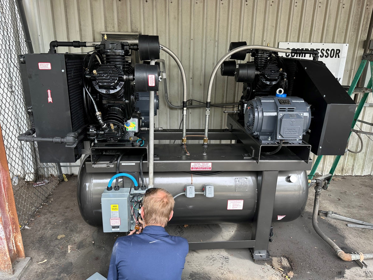 A Region Equipment technician servicing a commercial air compressor