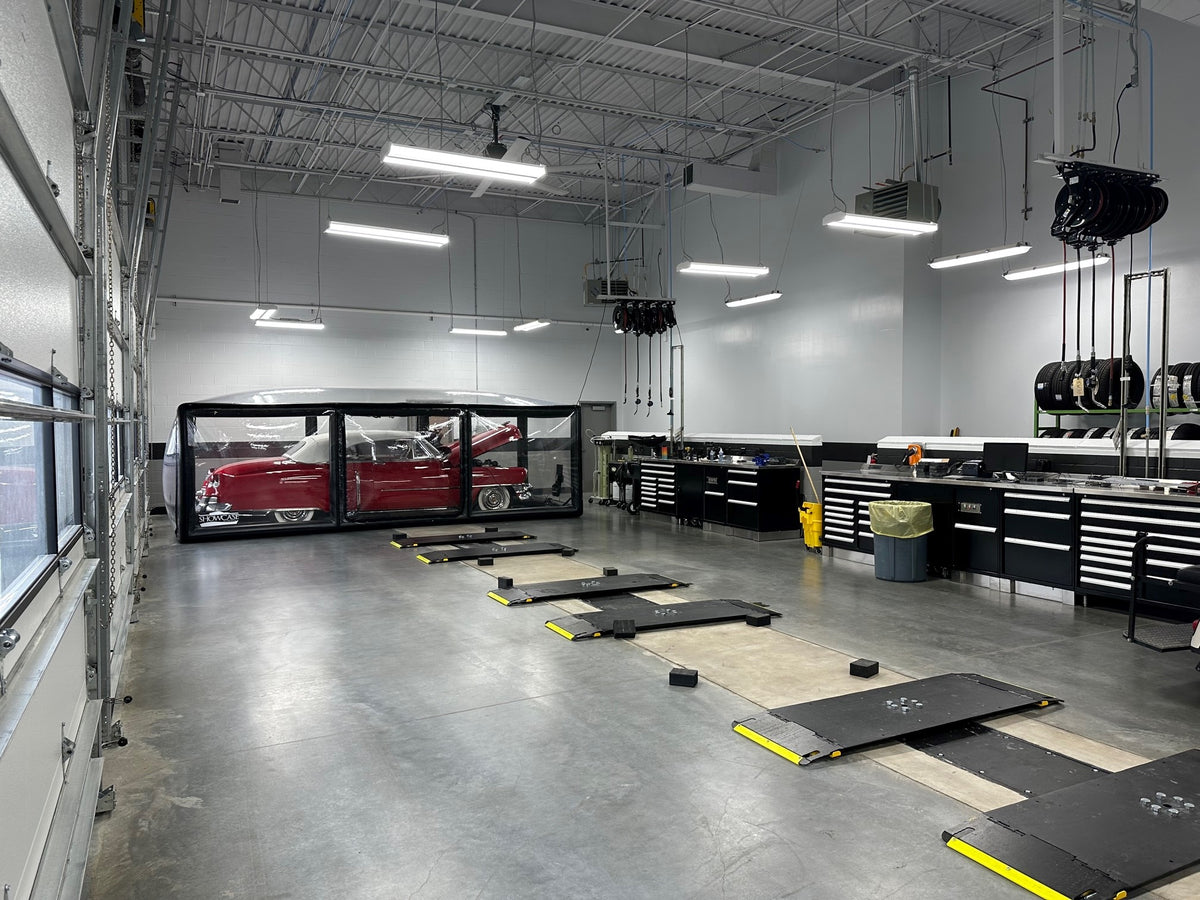 Completed fleet shop infrastructure with vehicle service bays and organized workstations