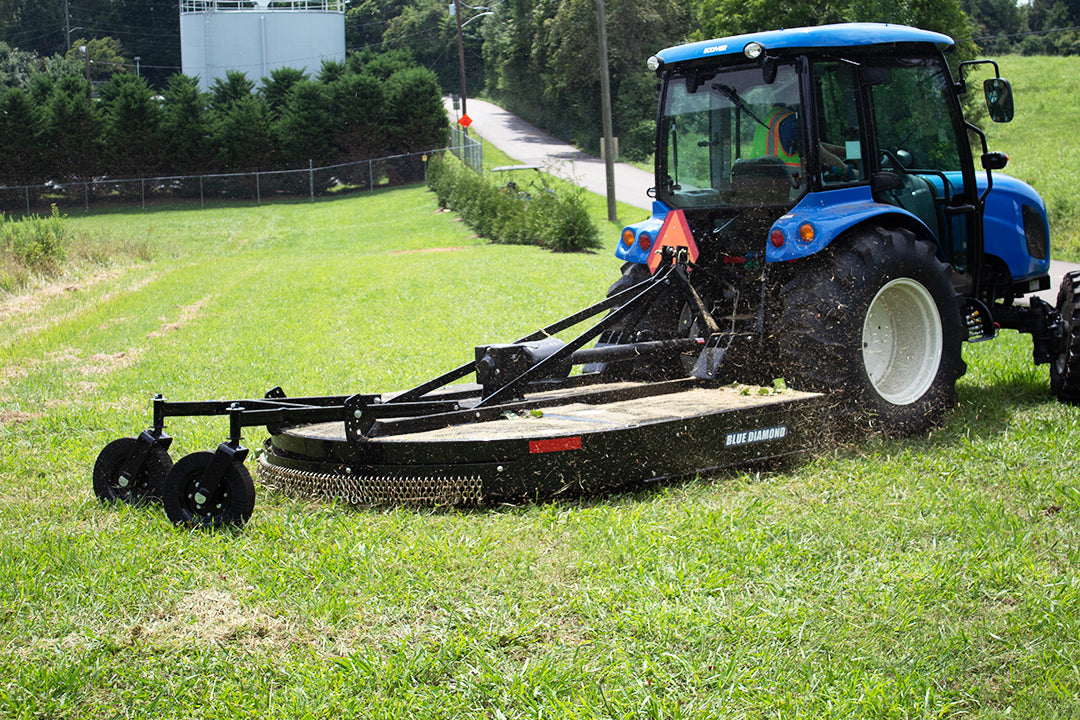 Blue Diamond Medium Duty Tractor Rotary Cutter — mounted on a tractor mowing grass