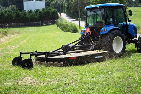 Blue Diamond Medium Duty Tractor Rotary Cutter — mounted on a tractor mowing grass