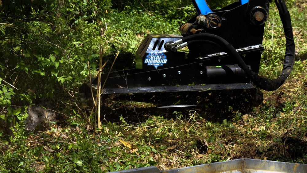 Close-up of Blue Diamond heavy duty mini excavator brush cutter cutting vegetation