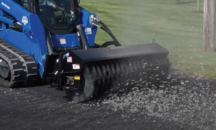 Blue Diamond Heavy Duty Series 2 Angle Broom — mounted on a compact track loader sweeping