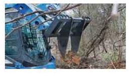 Blue Diamond Tree Grubber — Extreme Duty — mounted on a compact track loader