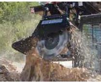 Blue Diamond Stump Grinder — mounted on a compact track loader grinding a stump
