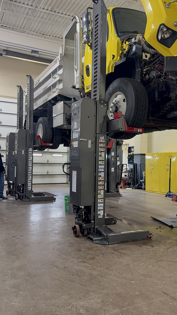 Gray mobile column lifts for heavy-duty fleet vehicle maintenance